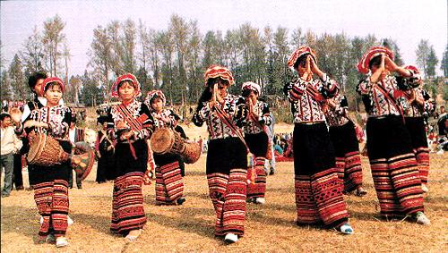 Image containing Lahu people wearing traditional clothes, some of them have drums. They are celebrating the Kuota Festival.